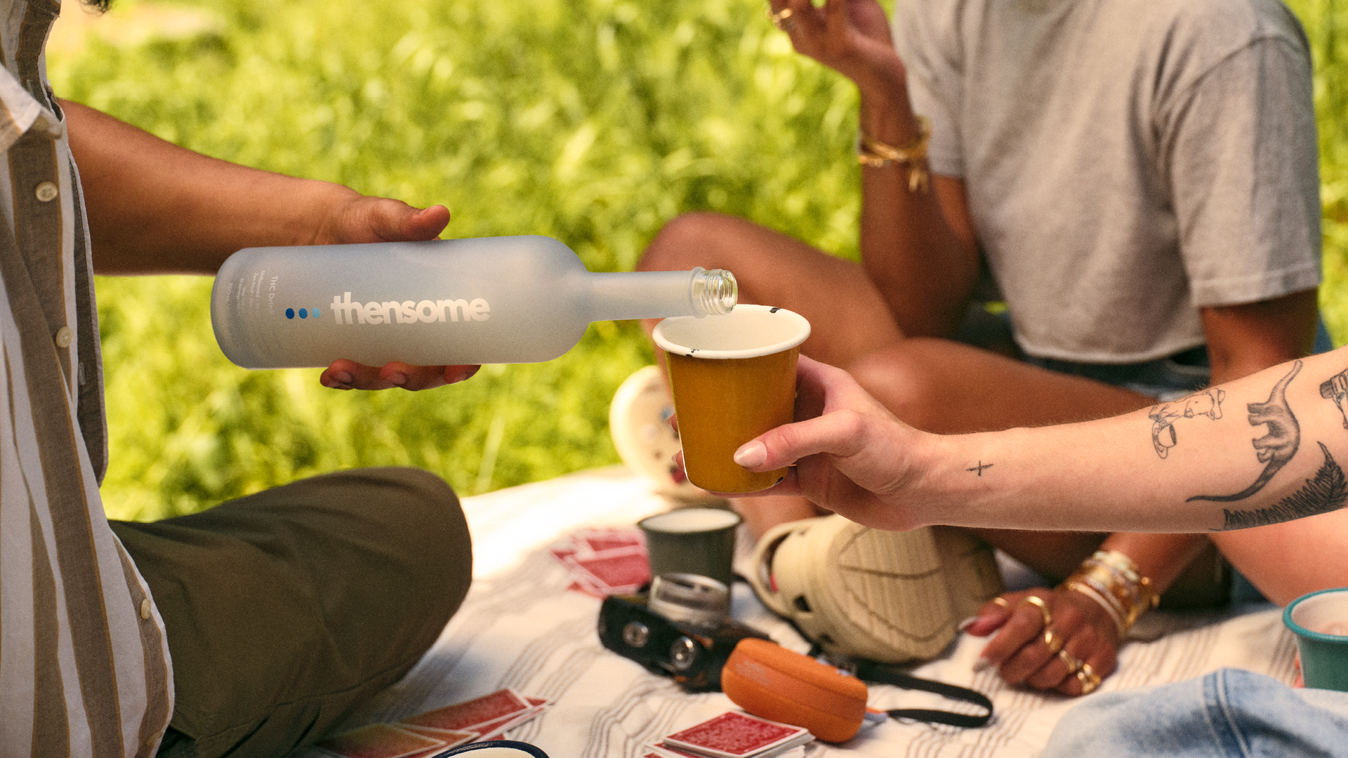 People pouring drink and laughing