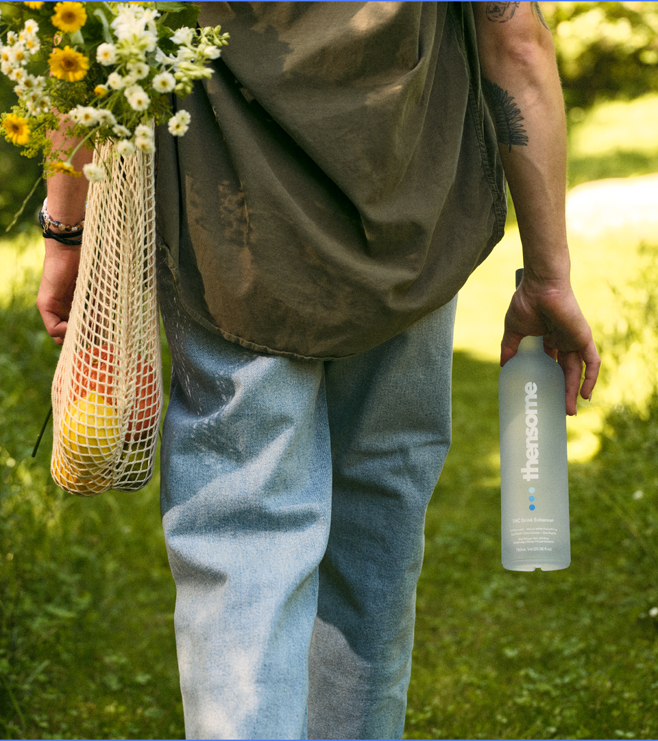 Woman walks with bottle in right hand