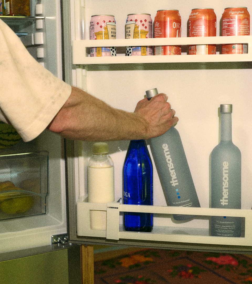 Man takes bottle out of the fridge