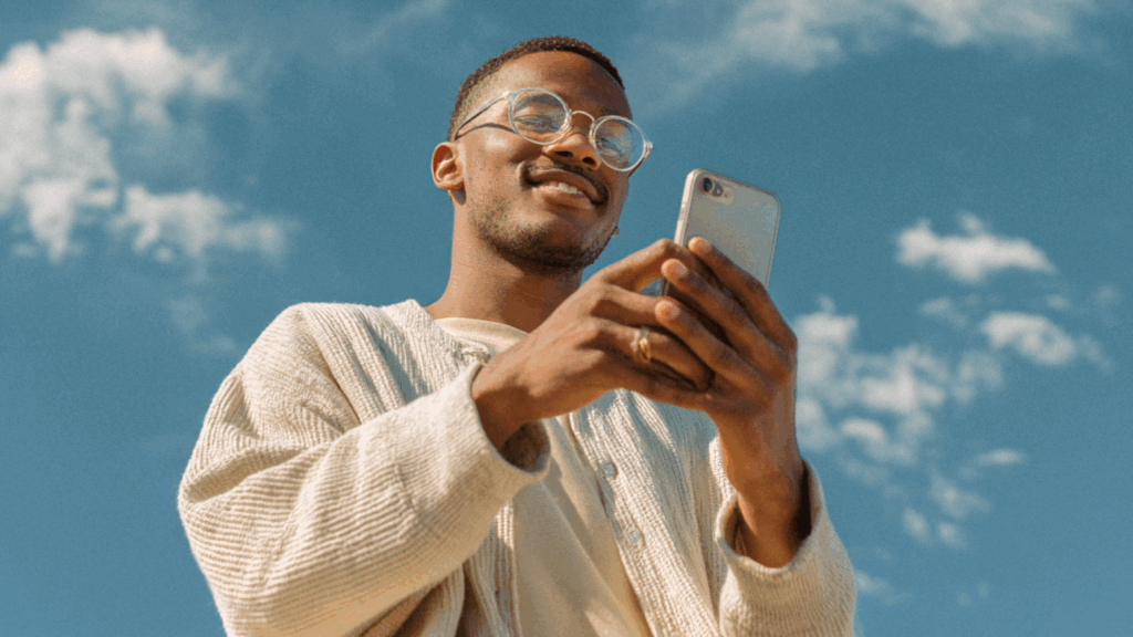 A man using a mobile phone. Sky background