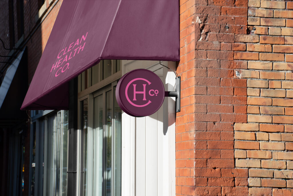 Shop Awning, in burgundy and pink lettering.