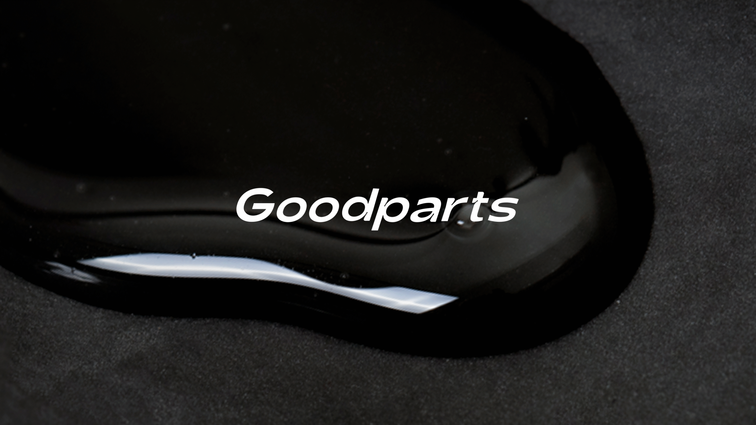 A white Goodparts logo on a black lube background